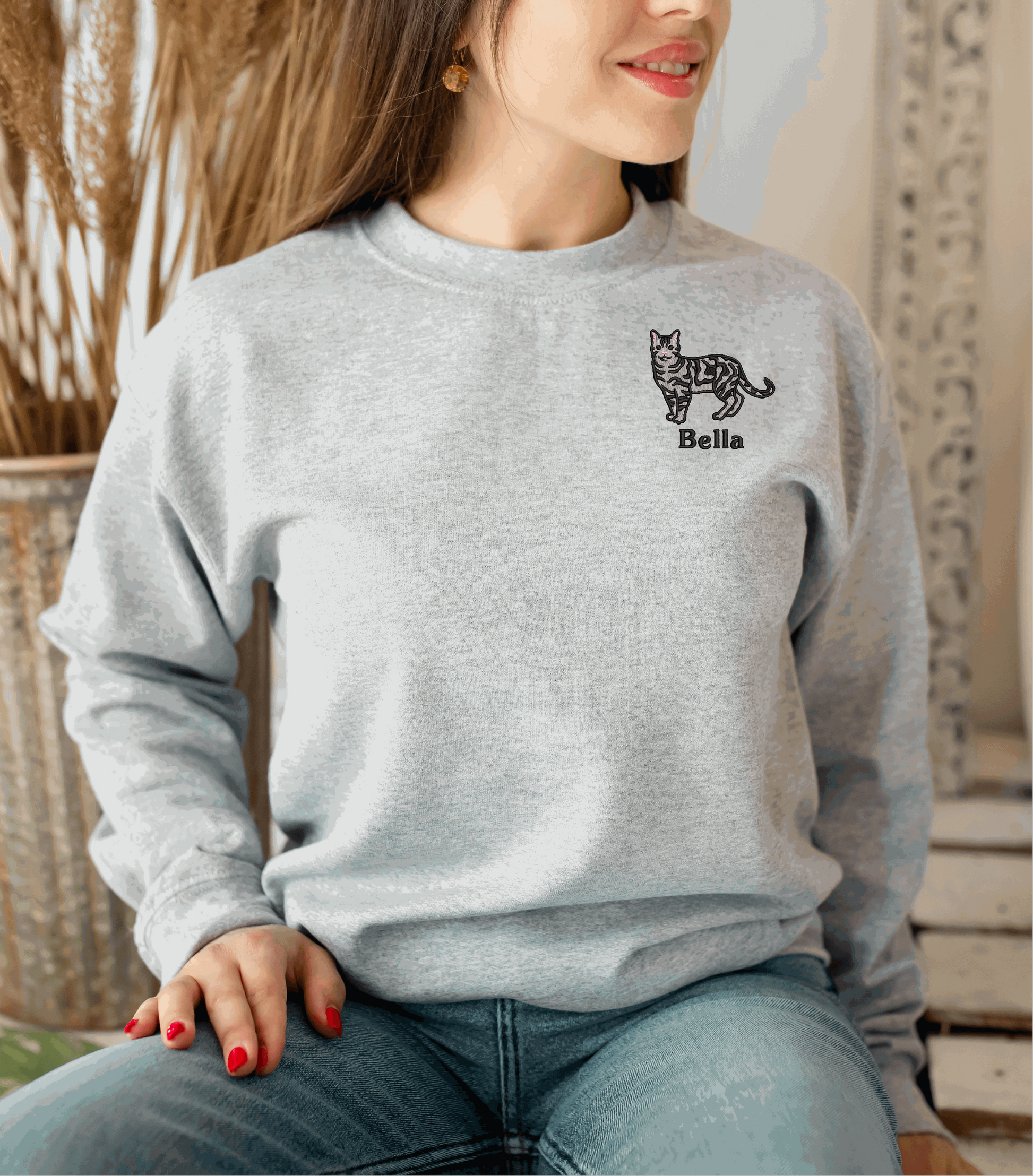 a woman sitting on a chair wearing a gray sweater
