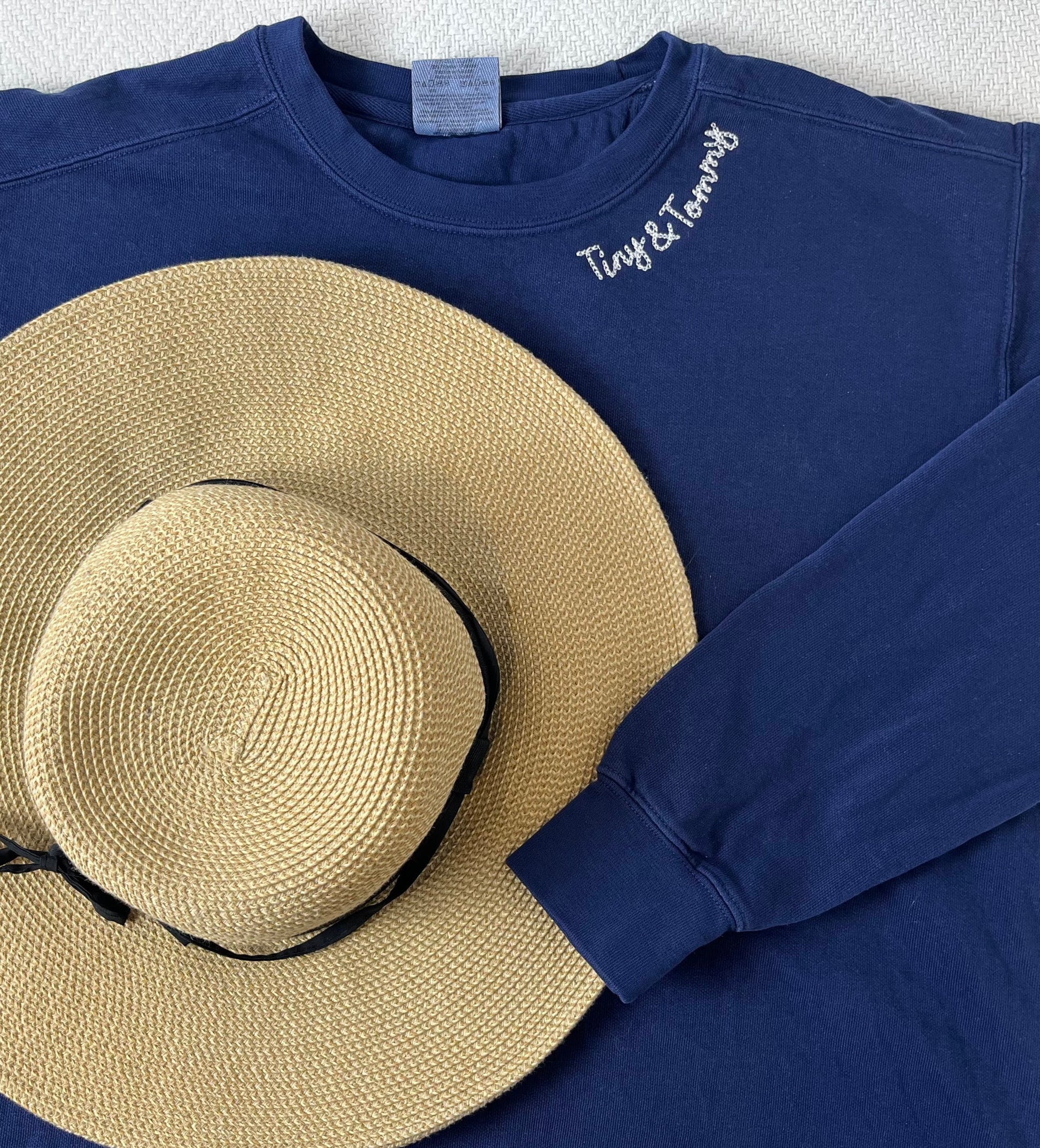 a blue shirt with a hat on top of it